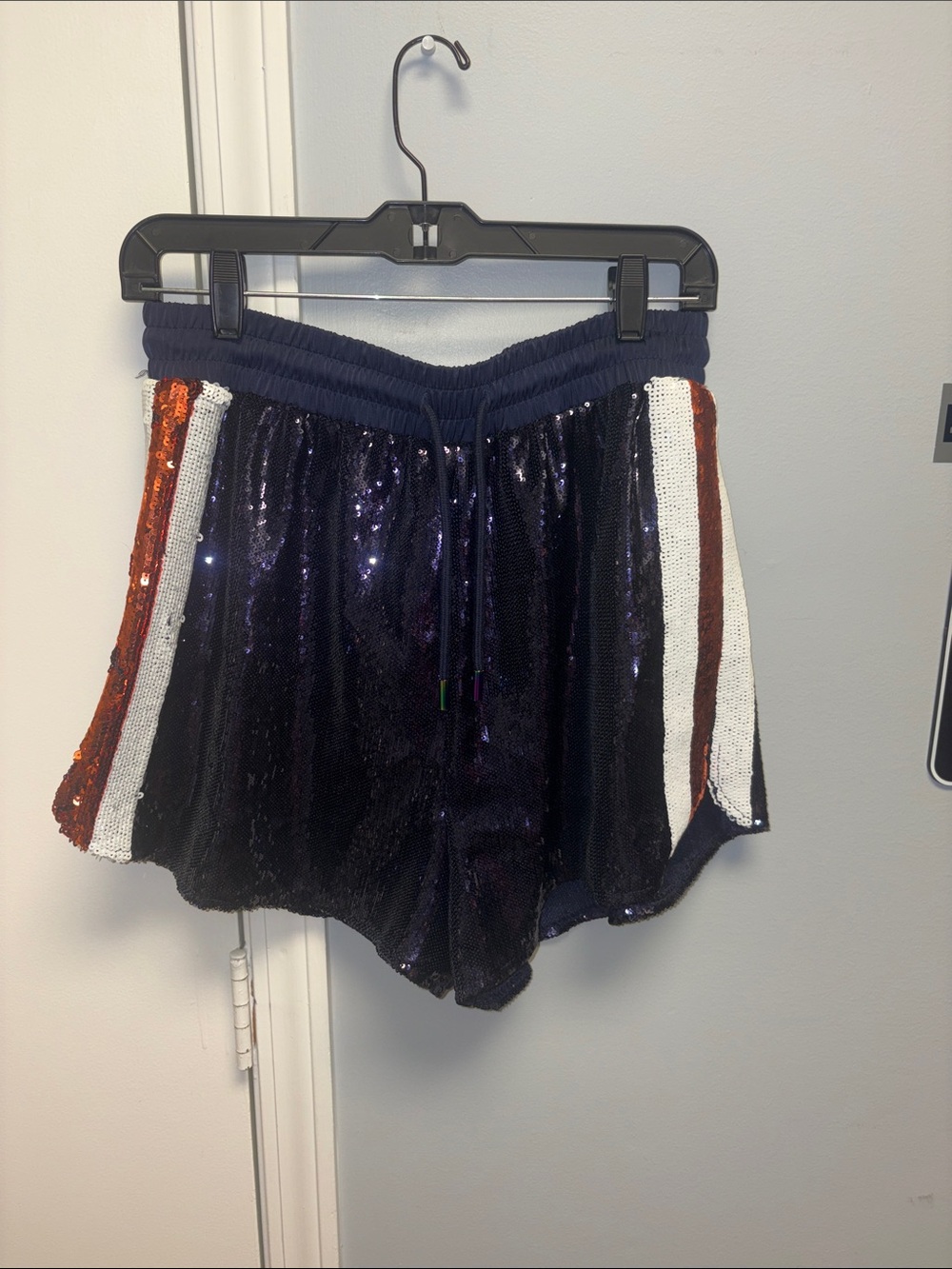 QUEEN OF SPARKLES Navy Sequin Athletic Shorts with White & orange Side Stripes